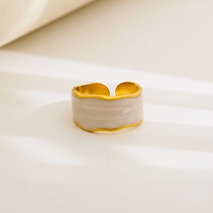 Detail of gold-plated wavy ring with marble texture enamel inlay and adjustable band