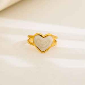 Close-up of heart-shaped white marble inlay on a gold-plated adjustable double-layer ring