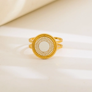 Macro detail of vintage gold double-band ring with white enamel and sunburst texture