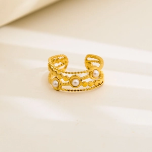 Detail of adjustable gold-plated stainless steel ring featuring three elegant white pearls