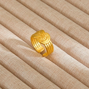 Detailed macro view of the gold-plated twisted rope texture on an adjustable ring band