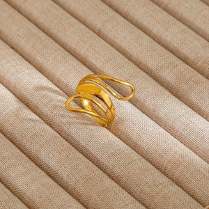 Detailed macro shot of an elegant gold multilayer irregular wave ring on a display