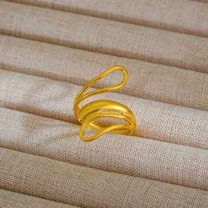 Dettaglio macro dell'anello dorato multistrato con contrasto tra finitura opaca e lucida