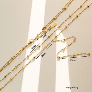 Detail of gold beaded Y-shaped chain with length markings and steel material tag