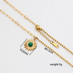 Detail of 18K gold plated sun pendant necklace with malachite stone and K18 hallmark