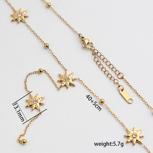 Layered gold necklace with star pendants, crystal accents and adjustable lobster clasp closure