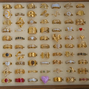 Bohemian gold plated rings set with heart and star patterns on beige velvet display