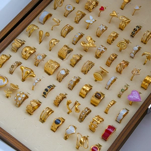 Collection of elegant gold-plated stainless steel rings with colorful enamel and pearls