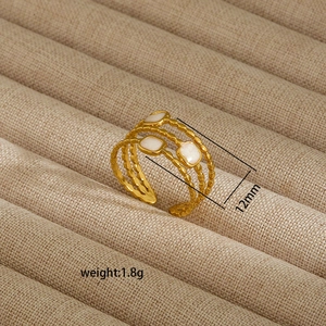 Detail view of 12mm wide irregular gold stainless steel ring with white square inlay