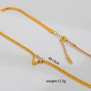 Detailed close-up of a gold snake chain necklace with marquise pendant and S.Steel tag