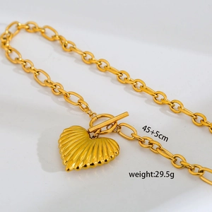 Detail view of gold stainless steel chunky chain necklace with heart pendant and OT toggle clasp
