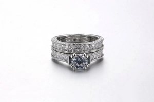 Detailed view of women's white gold stacked wedding rings with round and princess cut cubic zirconia