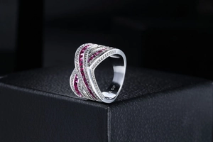 Macro view of 18K GP silver ring band featuring red rectangular stones and micro pavé crystals
