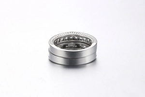 Close-up of platinum plated wedding ring set featuring channel set cubic zirconia stones