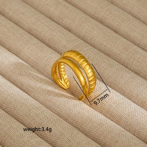 Detail showing irregular double-layered gold ear cuff with textured and smooth finishes