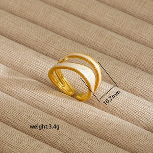 Detail view of irregular 18K gold plated ring with enamel inlay and 10.7mm width specs
