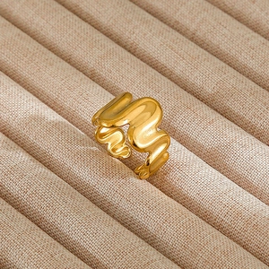 Detail of vintage gold wave ring with fluid molten texture on velvet tray