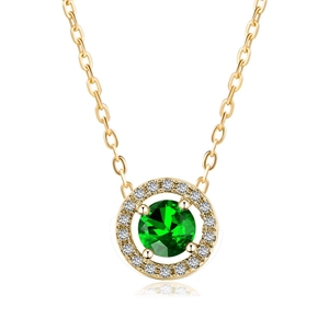 Macro detail of gold plated necklace with a round green gemstone and halo diamonds