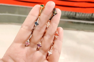 Detail of colorful marquise cut zirconia rings on hand in various plating colors