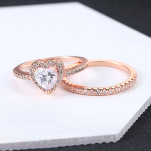 Rose gold heart-shaped zircon ring set on marble surface for bridal jewelry