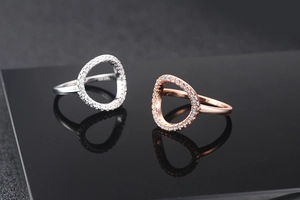 Detail of rose gold and silver open circle rings with sparkling cubic zirconia pavé