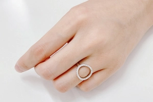 Detailed view of women's O-shaped ring with pavé-set cubic zirconia on a silver band