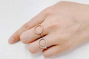 Detailed view of hollow O-shaped rings with rose gold and silver finish with pavé zircon