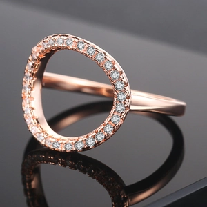 Rose gold hollow O-ring for women with pavé cubic zirconia on a dark mirror background