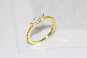 Detail of 14k gold plated ring featuring marquise cut zircon and pavé setting