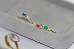 Detailed macro view of 14K gold plated engagement rings with rectangular zircon stones