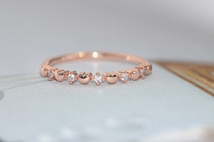 Detail of rose gold heart ring featuring sparkling zircon stones in a sleek pave setting
