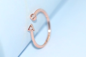 Detailed macro view of S925 rose gold ring featuring round and triangle zircon stones