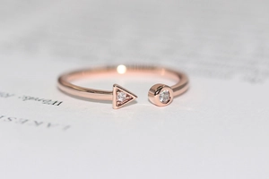 Detail of rose gold open ring with geometric micro-pave cubic zirconia settings