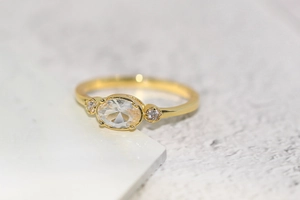 Detailed close-up of 14k gold plated ring with oval zircon and mirror finish