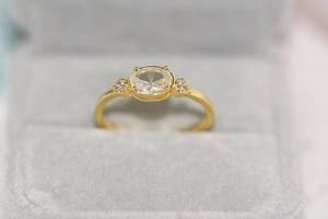 Macro shot of 14k gold plated ring with oval zircon stone in a velvet jewelry box