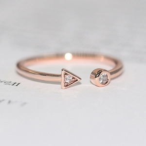 Minimalist geometric open ring in rose gold with micro-set triangle and round zircons