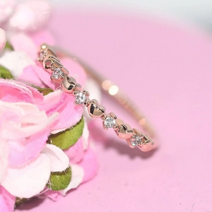 Elegant rose gold thin ring with hollow heart patterns and cubic zirconia stones