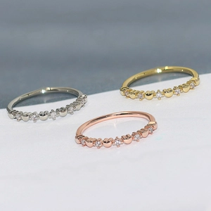 Three dainty heart rings in gold, silver, and rose gold with zircon stones