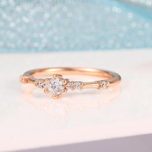 Elegant rose gold women ring with seven sparkling crystals on minimalist band