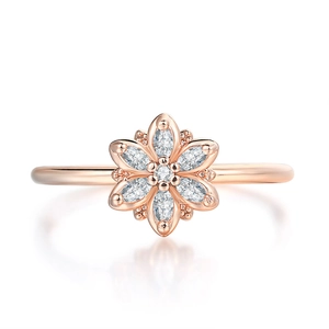 Detail of rose gold flower ring with marquise-cut zircons and polished finish