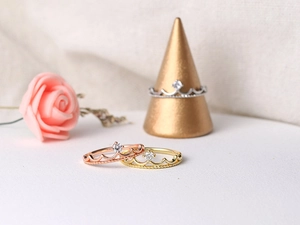 Macro view of crown rings in gold, rose gold and silver finishes with zircon stones