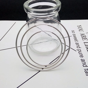 Three pairs of minimalist 925 sterling silver hoop earrings in varying sizes on a glass bottle
