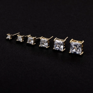 Macro shot of six pairs of square cut zircon earrings in graduated sizes and gold plating
