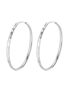 Macro shot of large 925 silver hoop earrings featuring diamond-cut textured surface
