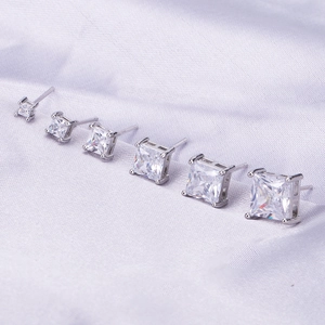 Detailed view of square cubic zirconia stud earrings in six different sizes with four-prong settings