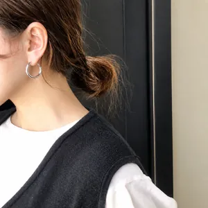 Polished 925 silver hoop earrings on female model for elegant minimalist style