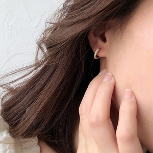 Close-up of gold s925 silver hoop earrings with clear cubic zirconia pavé setting