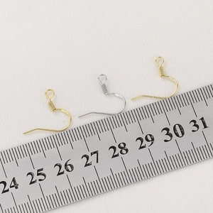 Detail of S925 sterling silver earring hooks with S925 stamp shown on measurement scale