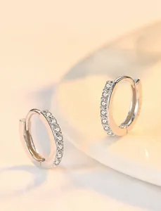 Macro detail of silver hoop earrings with cubic zirconia micro-pave setting