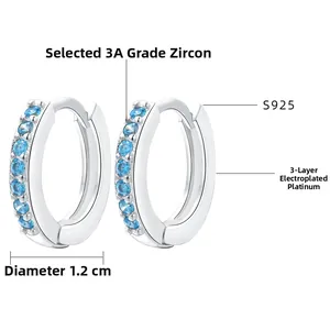 Detail of S925 silver huggie earrings with 3A blue zircon and white gold plating